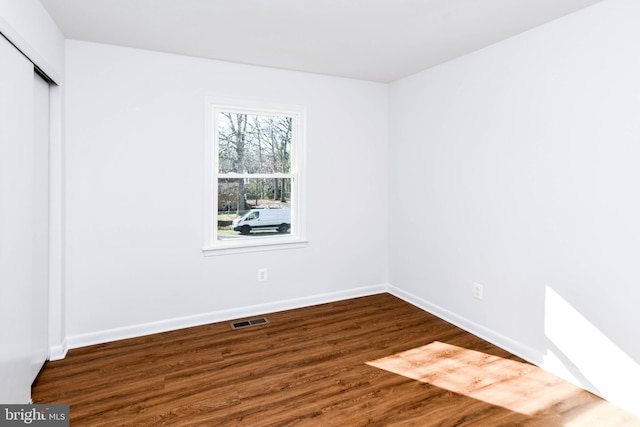 unfurnished bedroom featuring dark wood-type flooring