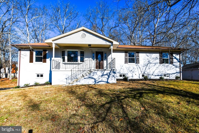 view of front of house with a front yard and covered porch