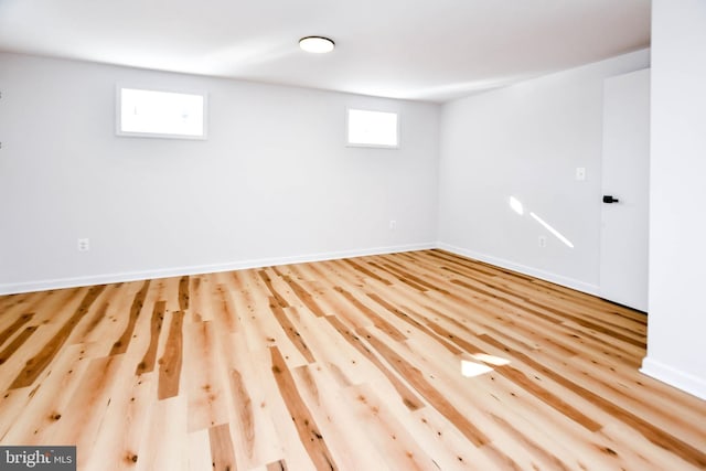 basement with light hardwood / wood-style flooring