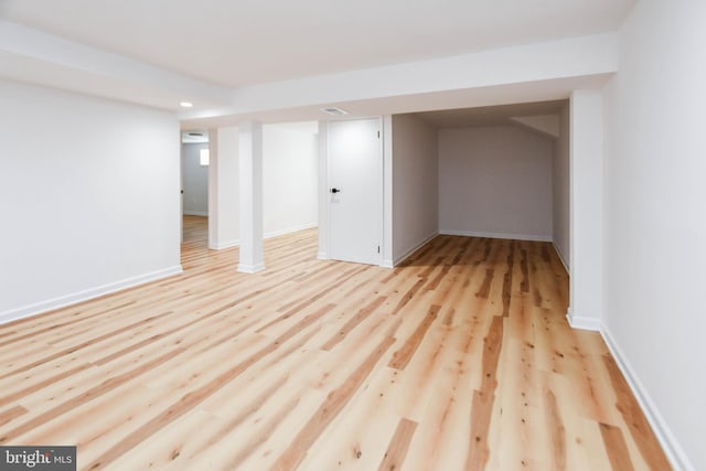 basement with light hardwood / wood-style flooring