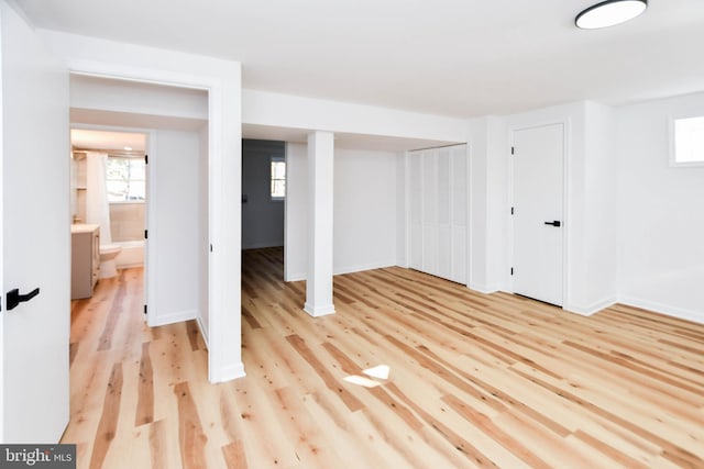 basement with light hardwood / wood-style flooring