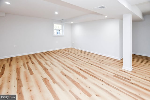 basement with light hardwood / wood-style flooring