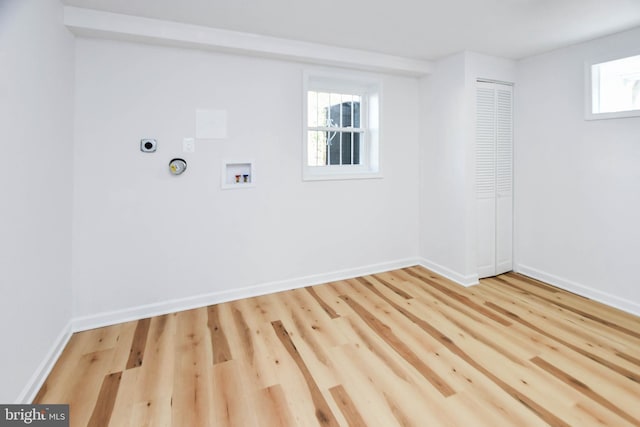 laundry room with electric dryer hookup, hookup for a washing machine, and light hardwood / wood-style flooring