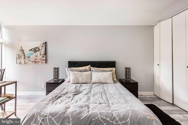 bedroom featuring light hardwood / wood-style flooring and a closet