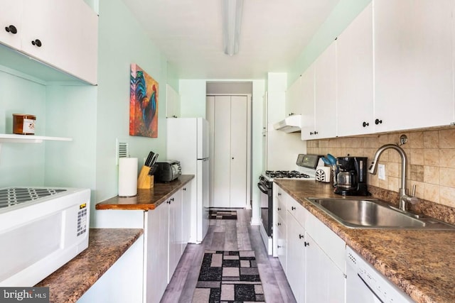 kitchen with dark hardwood / wood-style flooring, white cabinetry, sink, and white appliances