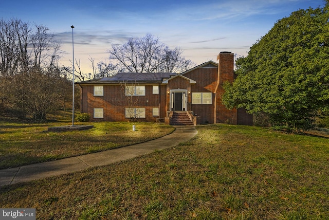 view of front of home with a lawn