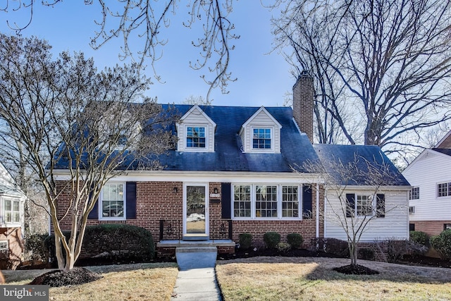 cape cod home with a front lawn