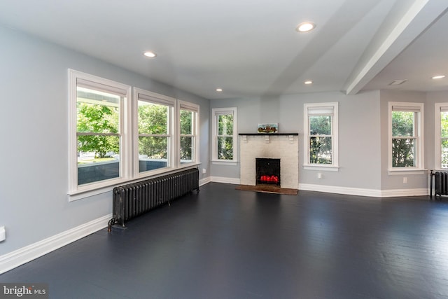 unfurnished living room featuring radiator