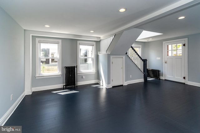 interior space featuring radiator heating unit and dark hardwood / wood-style flooring