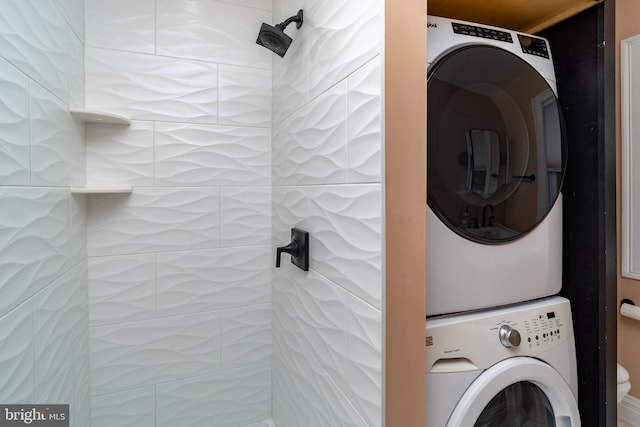 laundry room with stacked washer / drying machine