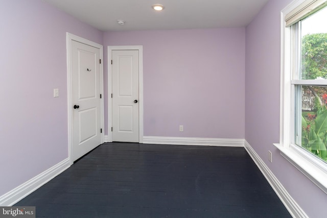 empty room with dark hardwood / wood-style floors