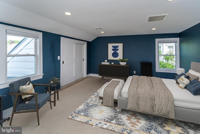 bedroom featuring carpet, radiator heating unit, and vaulted ceiling