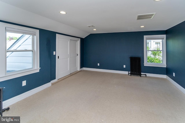 interior space featuring radiator and vaulted ceiling