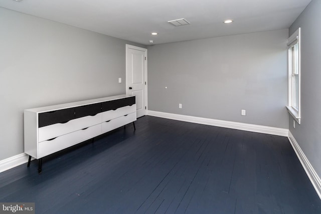 unfurnished bedroom featuring dark hardwood / wood-style flooring