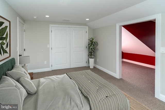 carpeted bedroom with lofted ceiling