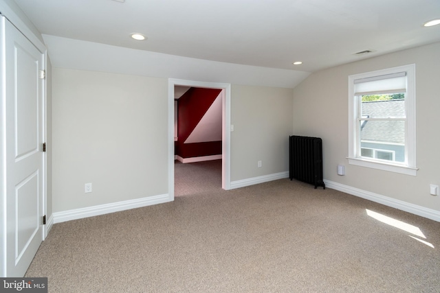 interior space with radiator and lofted ceiling