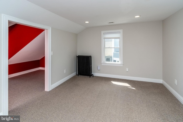 bonus room featuring carpet flooring, radiator heating unit, and vaulted ceiling