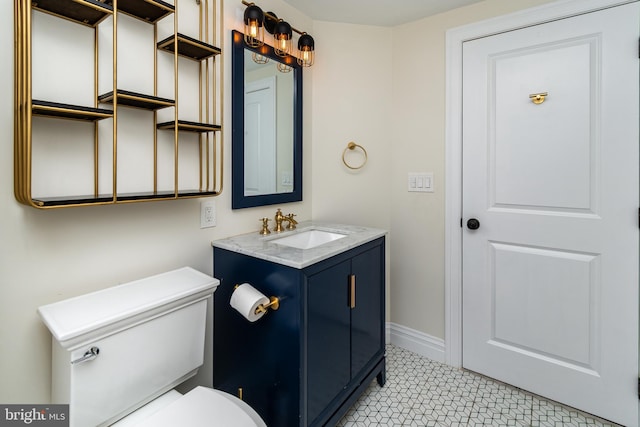 bathroom featuring tile patterned floors, vanity, and toilet