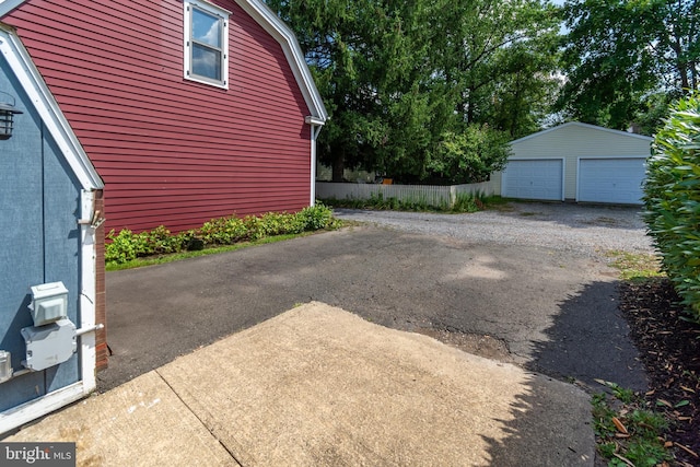 exterior space featuring a garage and an outdoor structure