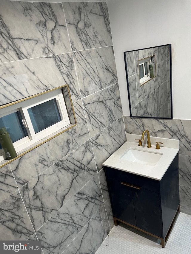 bathroom with vanity and tile walls