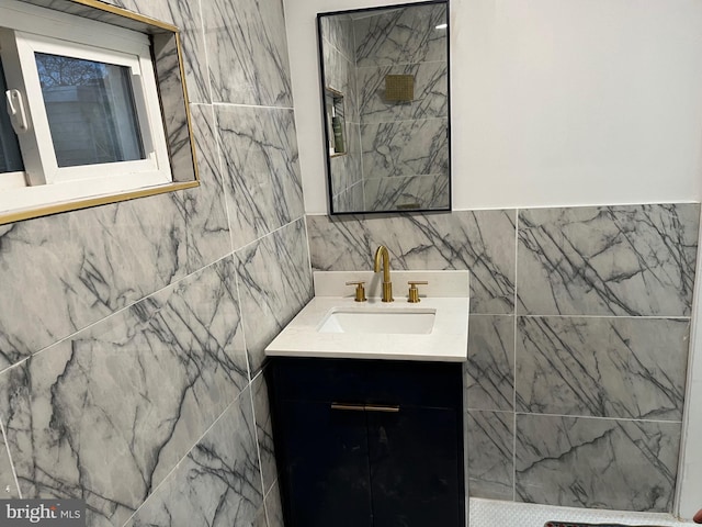 bathroom with vanity and tile walls