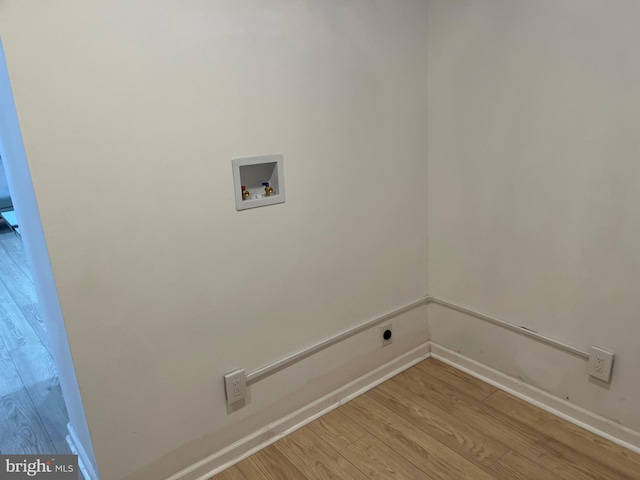 clothes washing area with washer hookup and light hardwood / wood-style floors