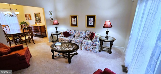 living room featuring light colored carpet and a notable chandelier