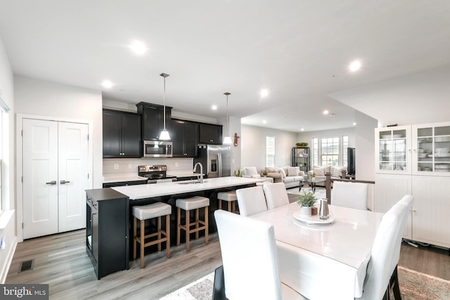 dining area featuring sink and light hardwood / wood-style floors