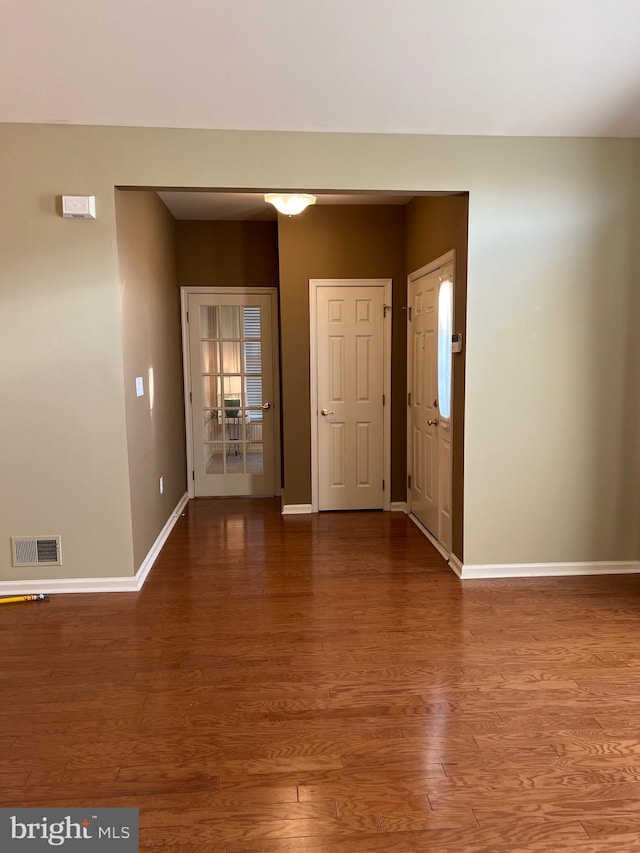 spare room with wood-type flooring