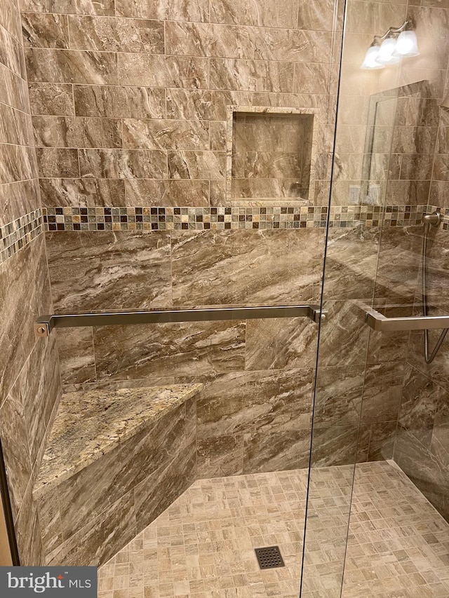 bathroom with a tile shower