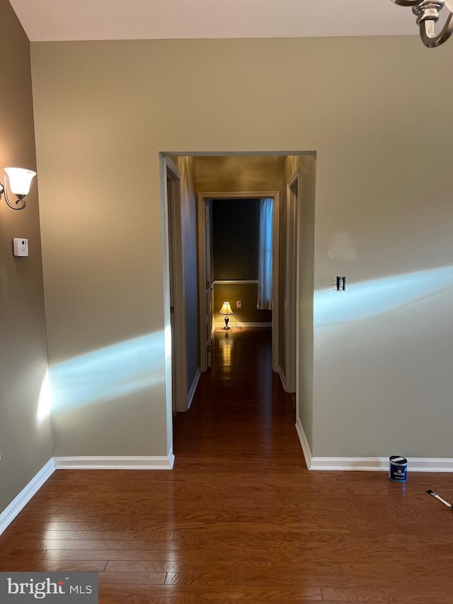 corridor with dark wood-type flooring