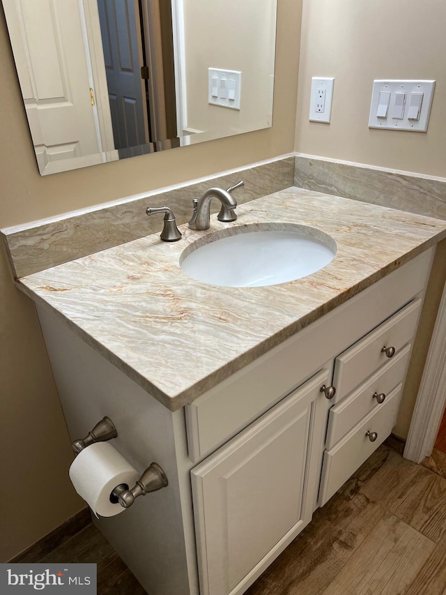 bathroom with hardwood / wood-style floors and vanity