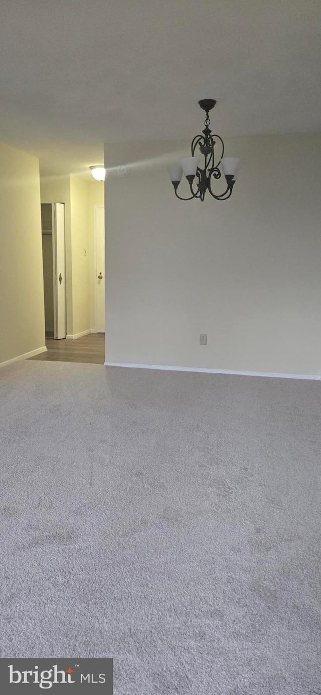 empty room featuring a notable chandelier