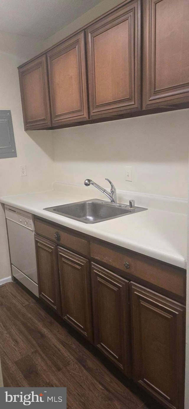 kitchen featuring dark wood-type flooring, sink, dishwasher, and dark brown cabinets