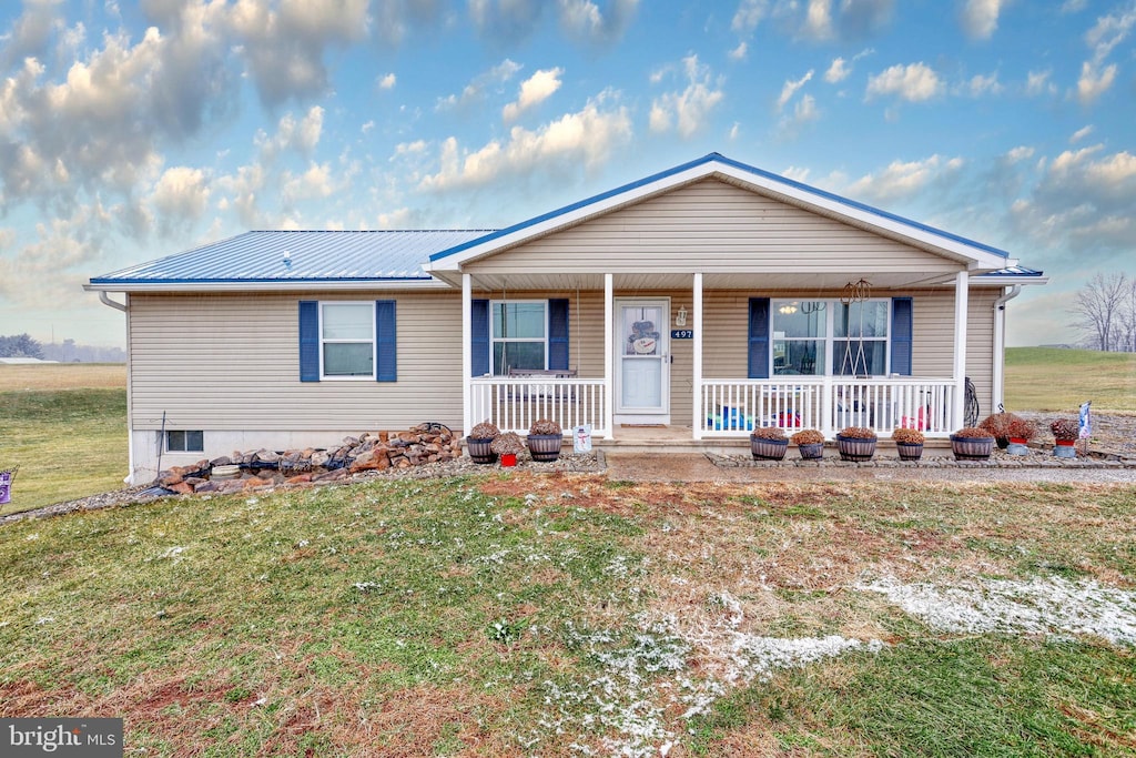 ranch-style home with a porch and a front yard