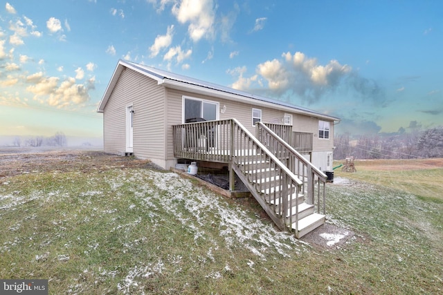 view of front of home with a yard and a wooden deck