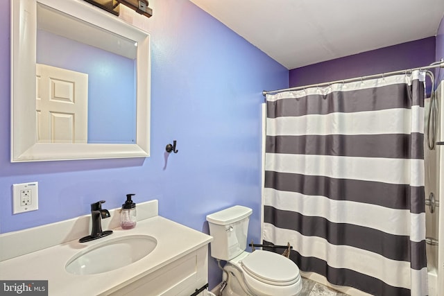 bathroom featuring vanity, a shower with shower curtain, and toilet