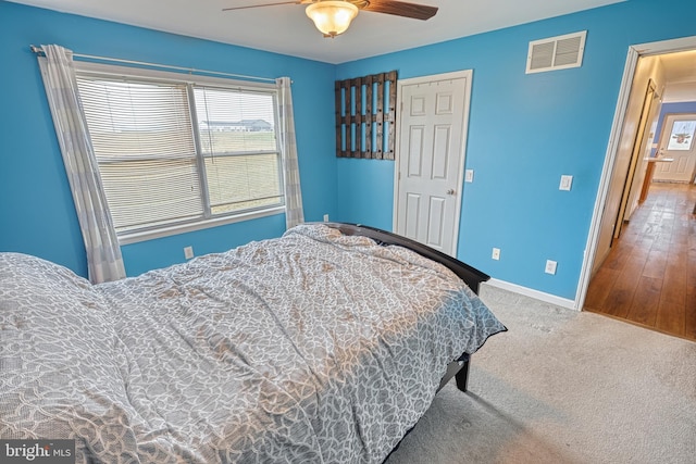 bedroom with carpet flooring, ceiling fan, and a closet