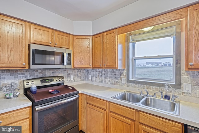 kitchen with stainless steel appliances, tasteful backsplash, and sink