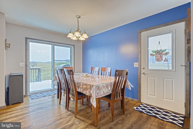 dining space featuring light hardwood / wood-style flooring and a notable chandelier