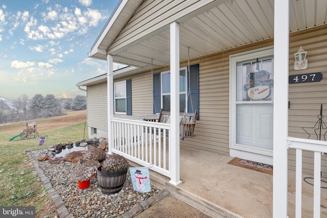 view of exterior entry with covered porch