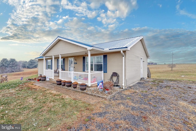 view of front of home with a porch and a front lawn