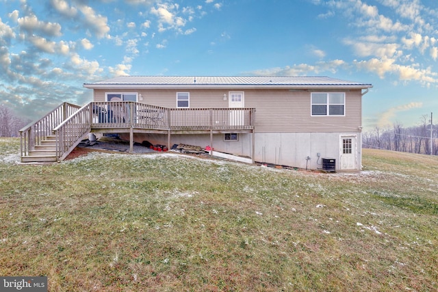 back of property featuring a deck, a yard, and central air condition unit