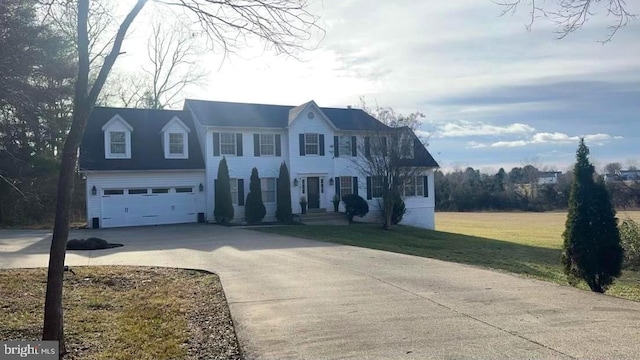 view of front of property with a front lawn and a garage