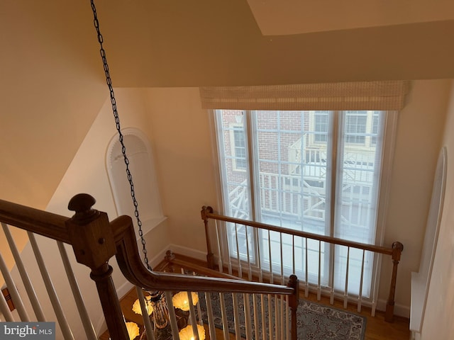 staircase with a wealth of natural light and hardwood / wood-style floors