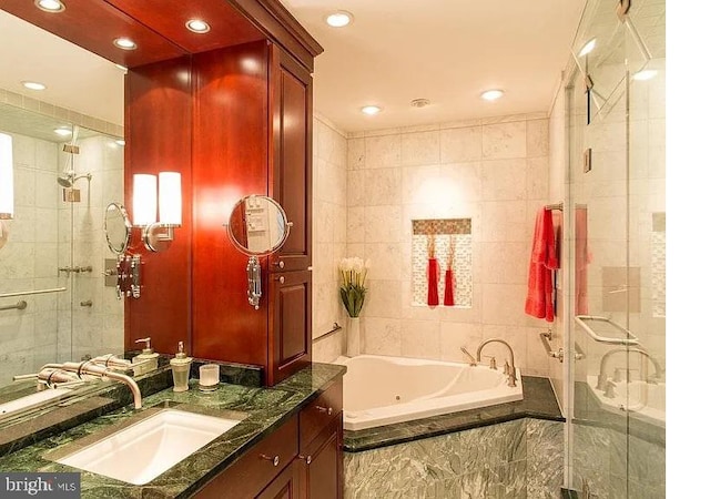 bathroom featuring tile walls, vanity, and shower with separate bathtub