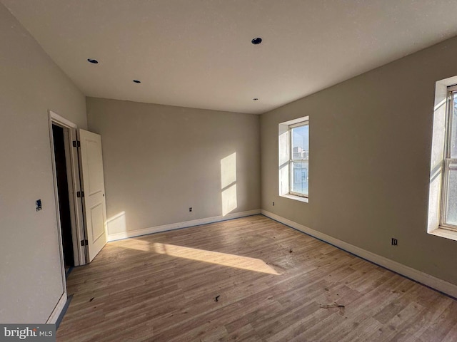 empty room with light hardwood / wood-style floors