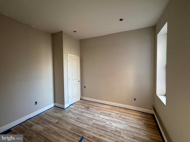 unfurnished room with light wood-type flooring