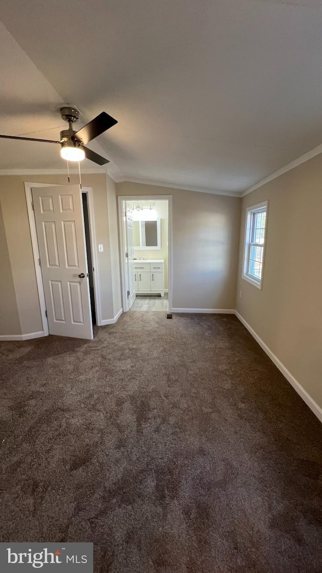 unfurnished bedroom with ornamental molding, carpet flooring, and baseboards