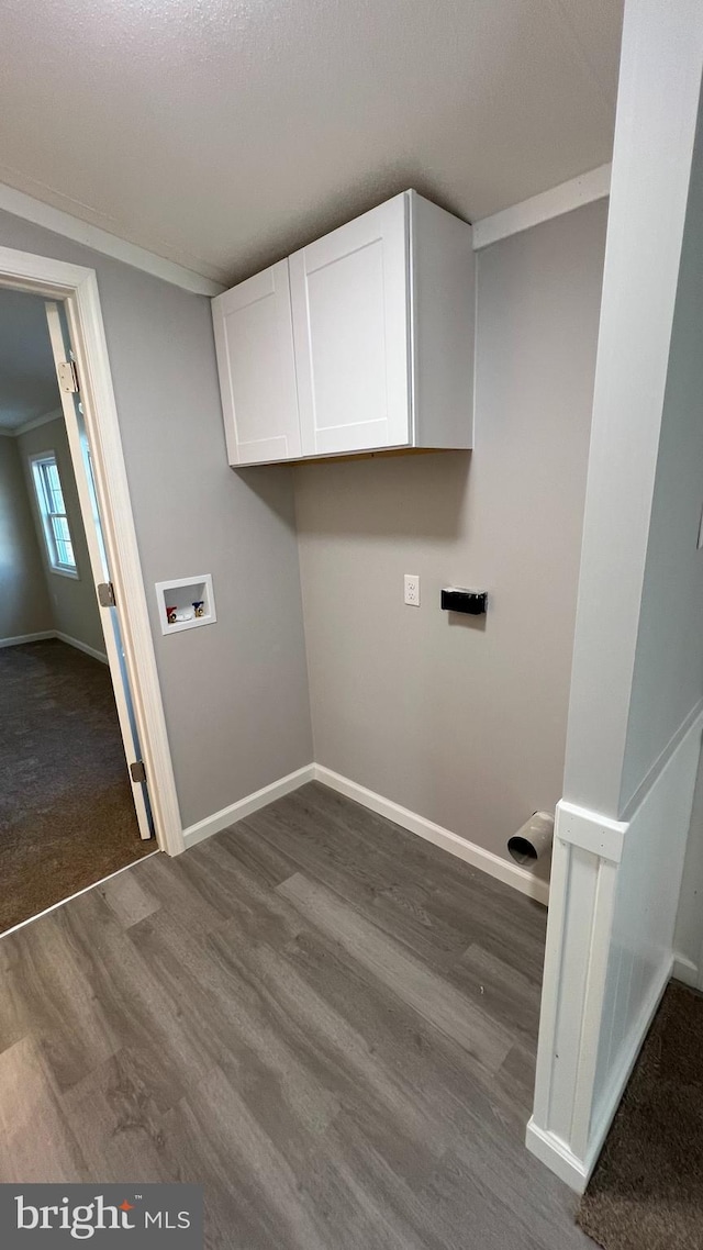 laundry room with hookup for a washing machine, baseboards, ornamental molding, cabinet space, and dark wood-style floors